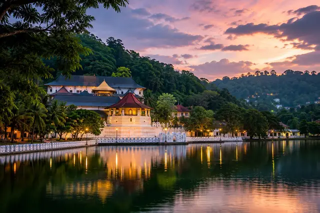 Temple of the Sacred Tooth reflected in Kandy Lake at dusk
