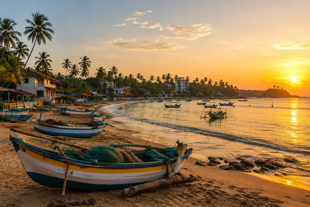 Weligama bay at sunset with boats and a palm-lined beach